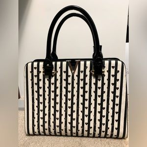 Black and white striped handbag with cutout hearts pattern